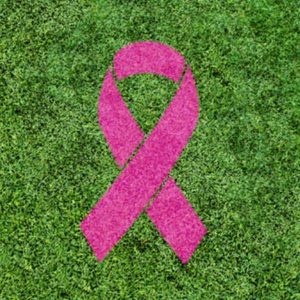 pink october logo on vegetal color grass
